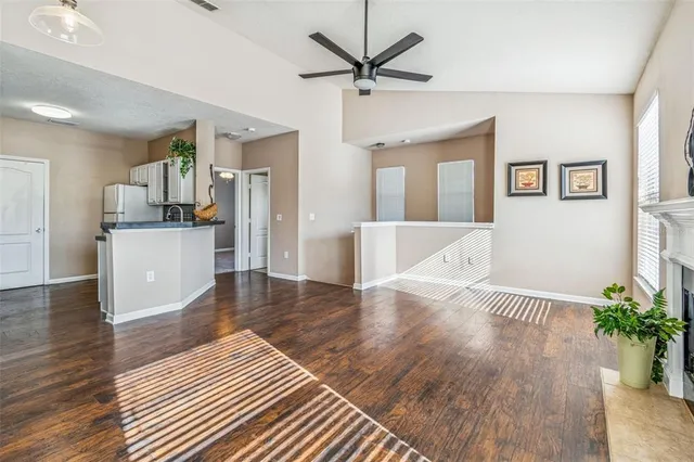 a view of an empty room with a fireplace and a window