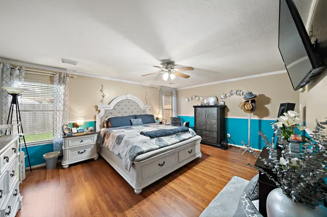 a bed room with a bed window and a chair