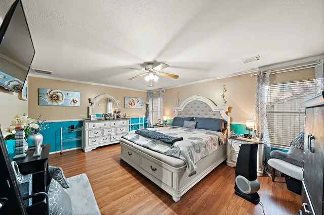 a bed room with a bed window and a chair