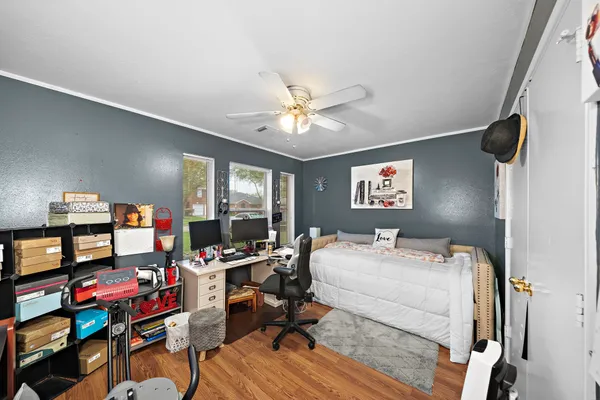 a room with furniture a flat screen tv and a book shelf