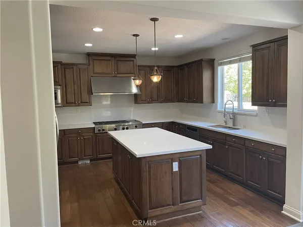 a kitchen with a sink appliances and cabinets