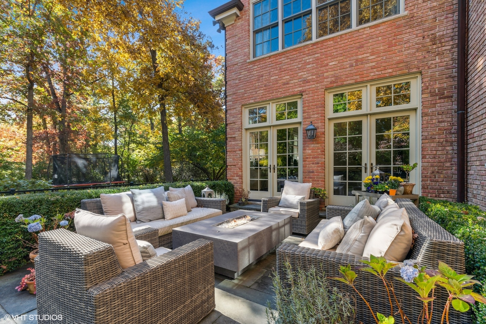 511 Cambridge Lane Lake Bluff, IL 60044 - Photo 44 of 58 a view of a patio with couches table and chairs with plants and trees