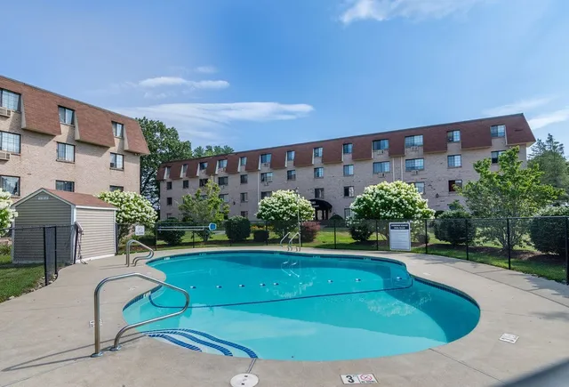 a swimming pool with outdoor seating and yard