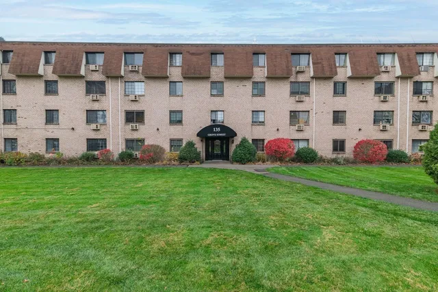 a front view of a building with garden