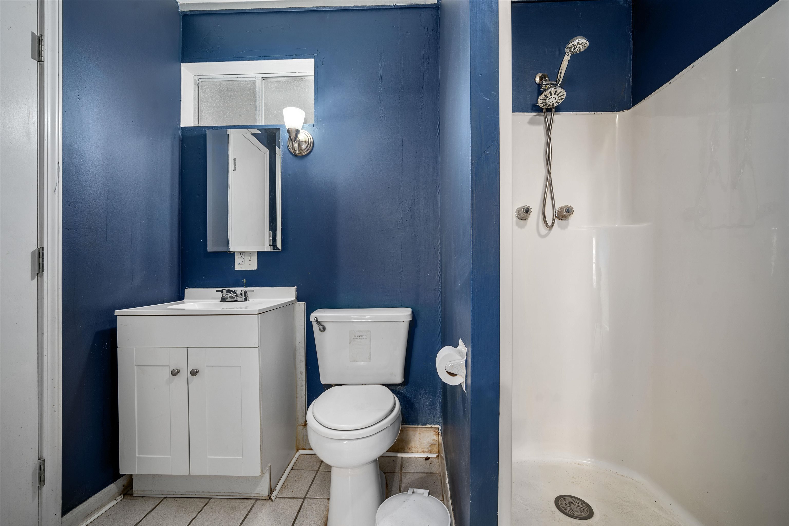 3014 Farcott Street Mobile, AL 36606 - Photo 14 of 26 Bathroom featuring a shower stall, vanity, and light tile patterned floors