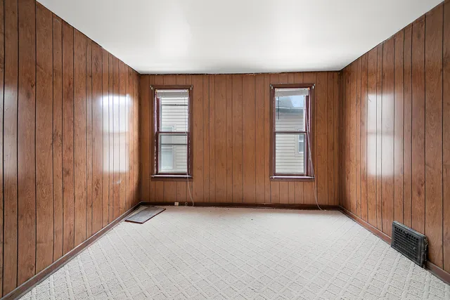 a view of white house with a yard covered in snow