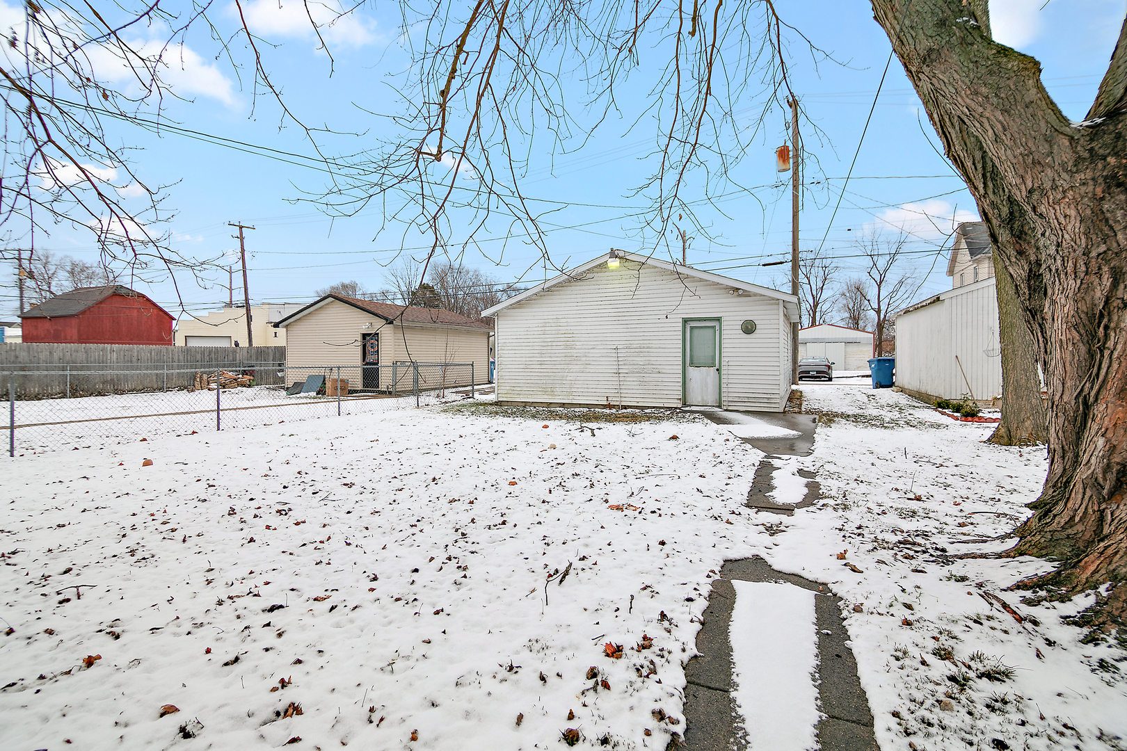 974 South Washington Avenue Kankakee, IL 60901 - Photo 13 of 14 a view of white house with a yard covered in snow