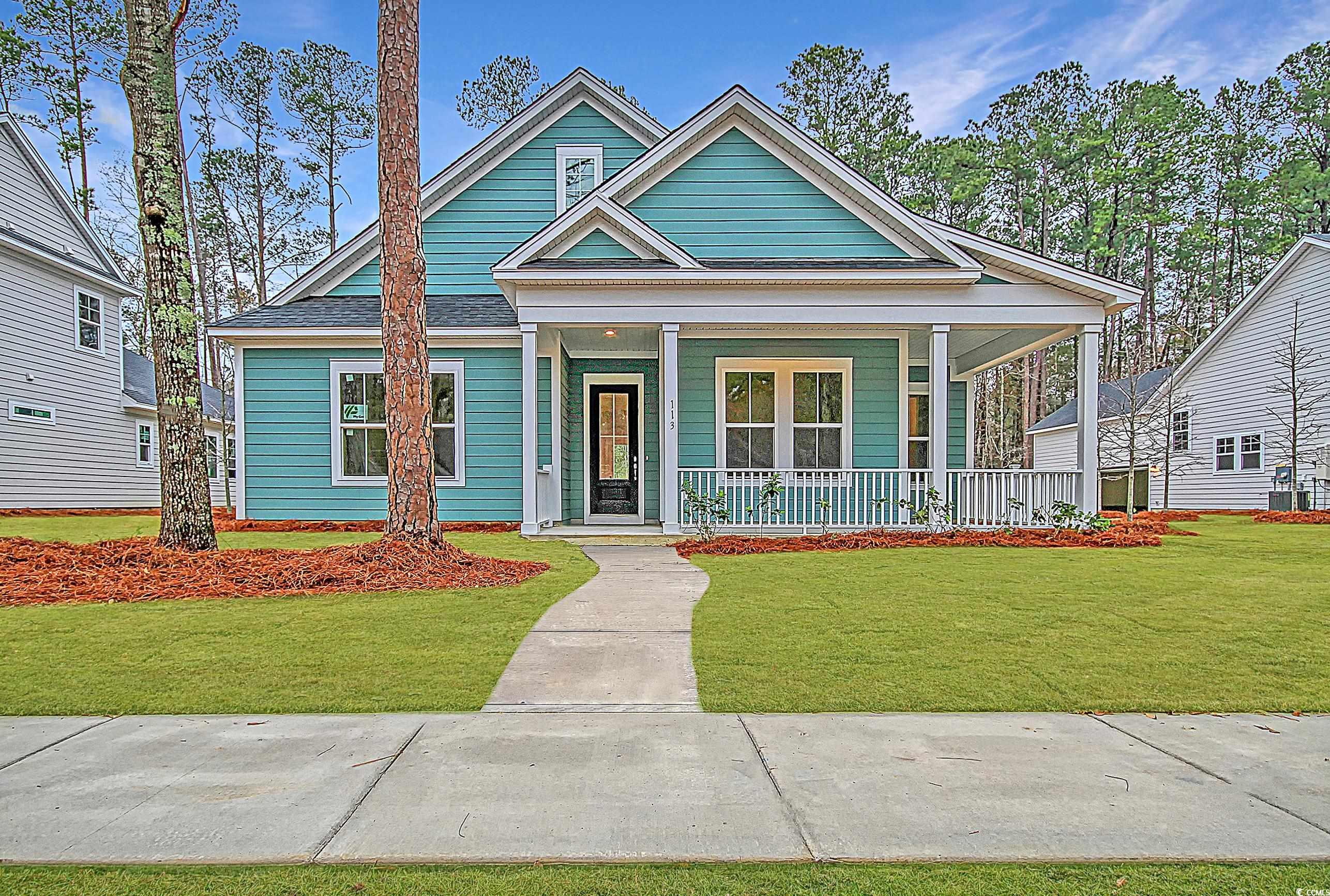 View of front of home with a porch and a front yard