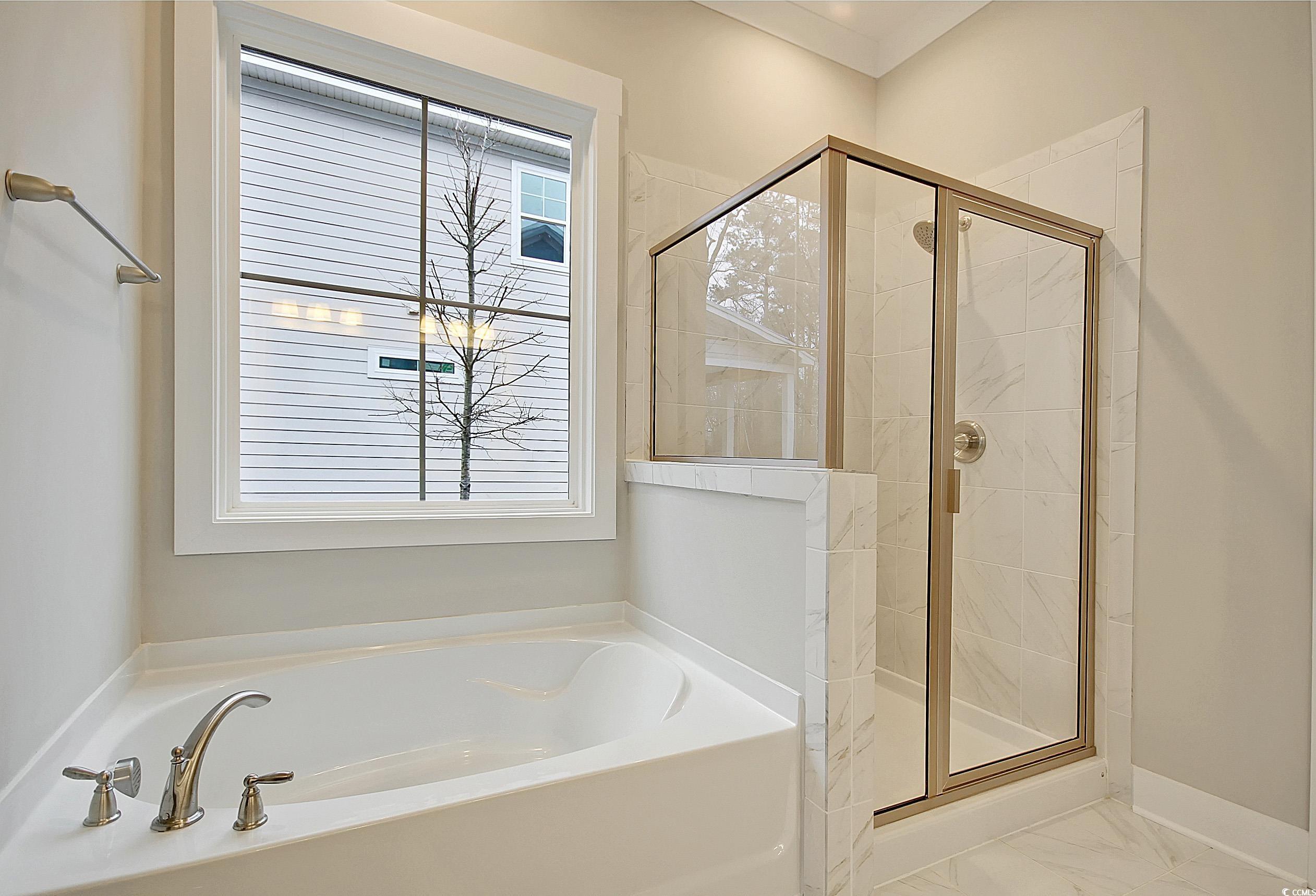 171 Pinebury Drive Georgetown, SC 29440 - Photo 11 of 30 Full bathroom with a stall shower, a bath, and light marble finish floors