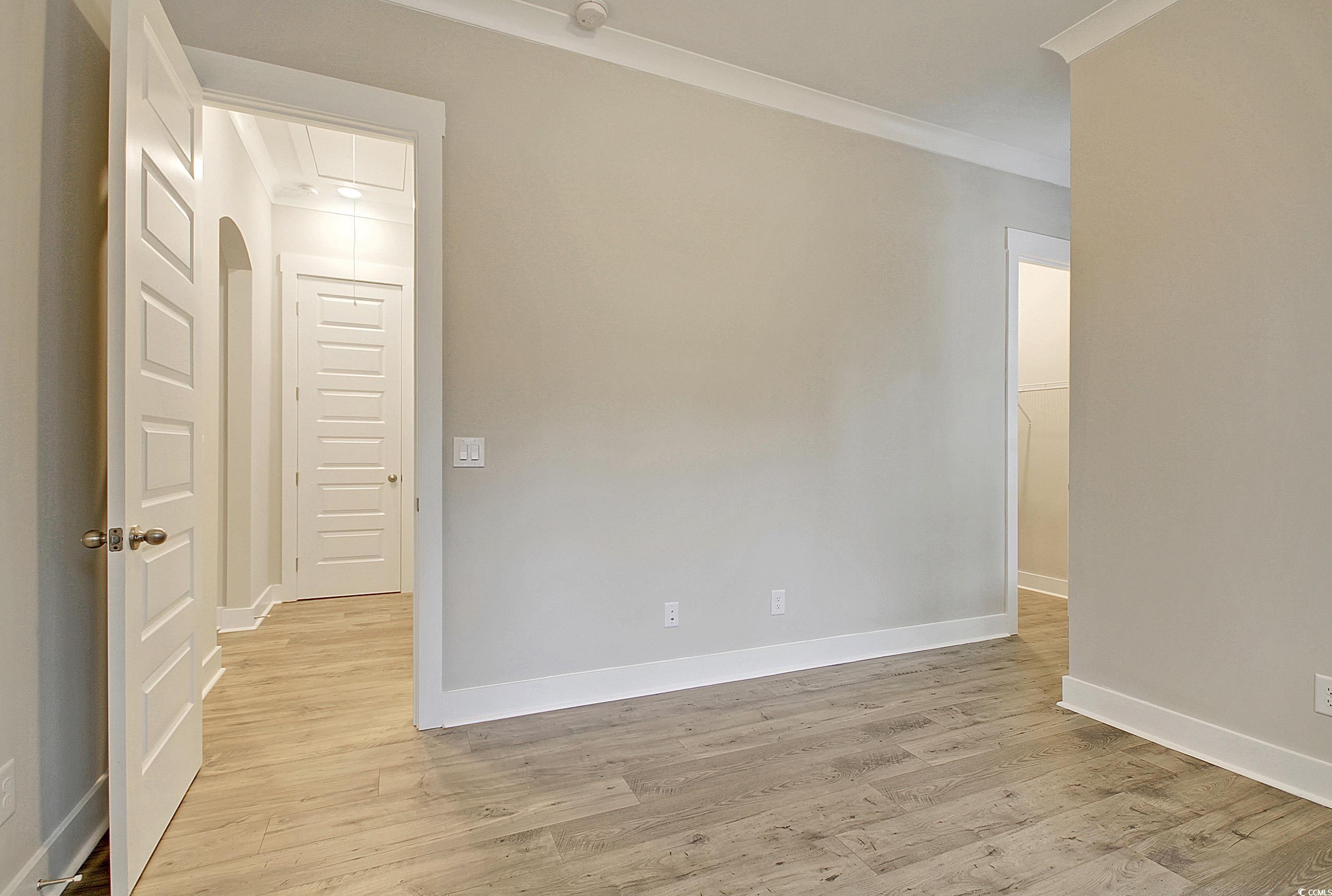 171 Pinebury Drive Georgetown, SC 29440 - Photo 14 of 30 Empty room with light wood-style floors and crown molding