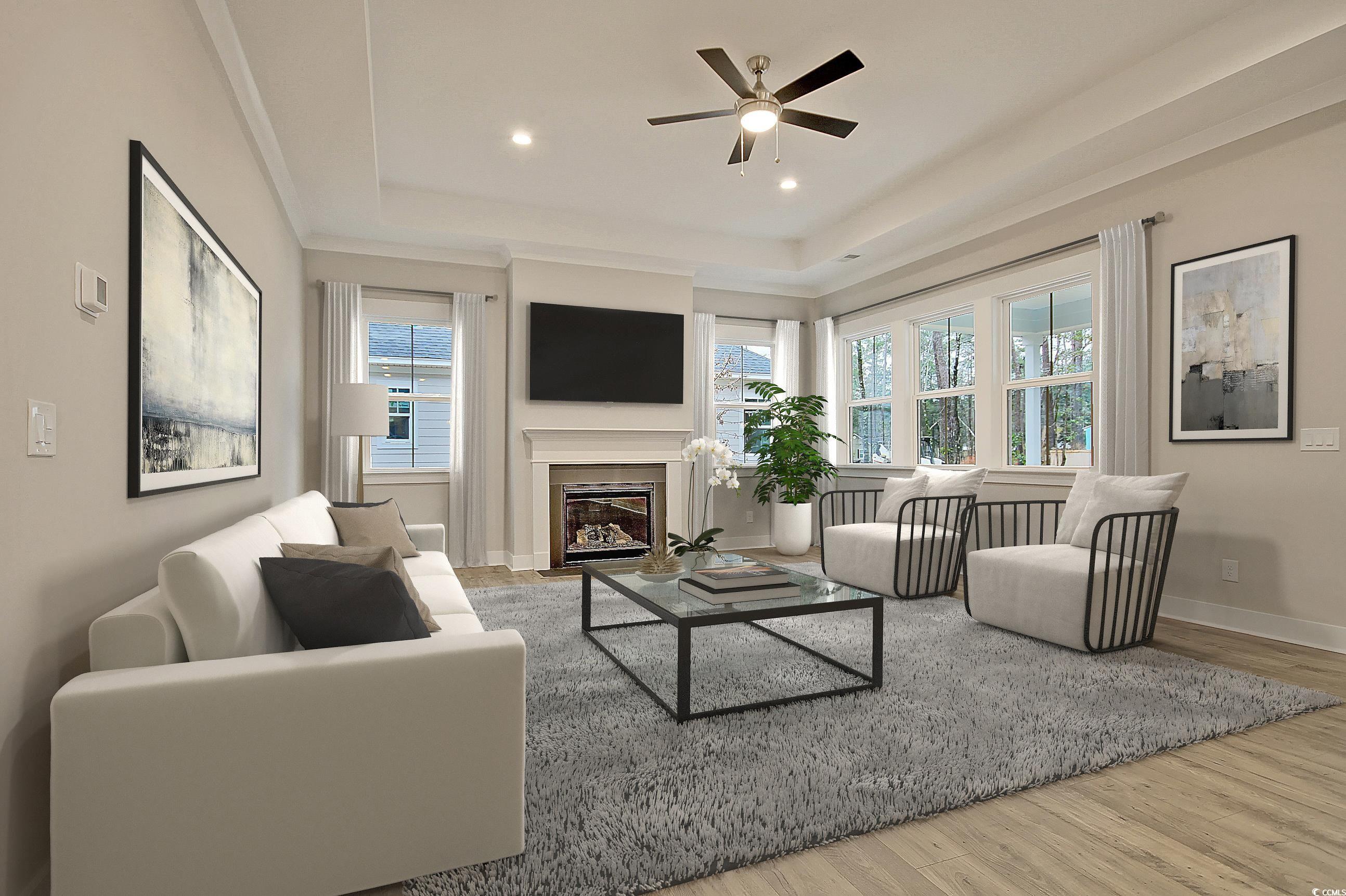 171 Pinebury Drive Georgetown, SC 29440 - Photo 6 of 30 Living room featuring wood finished floors, a fireplace with flush hearth, a tray ceiling, a ceiling fan, and recessed lighting