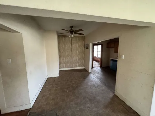 a view of empty room with a fireplace