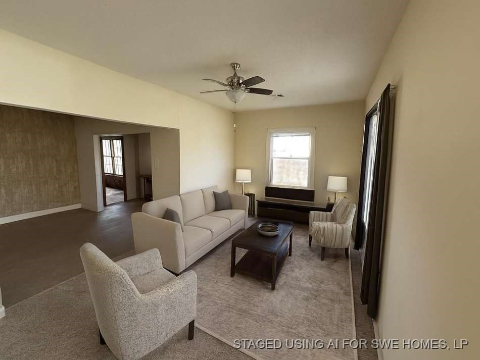 1302 South 23rd Street Temple, TX 76504 - Photo 6 of 13 a living room with furniture and a chandelier