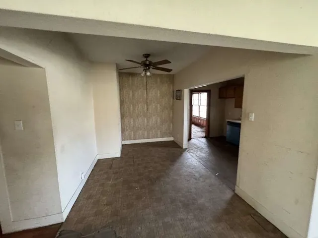 a view of empty room with a fireplace