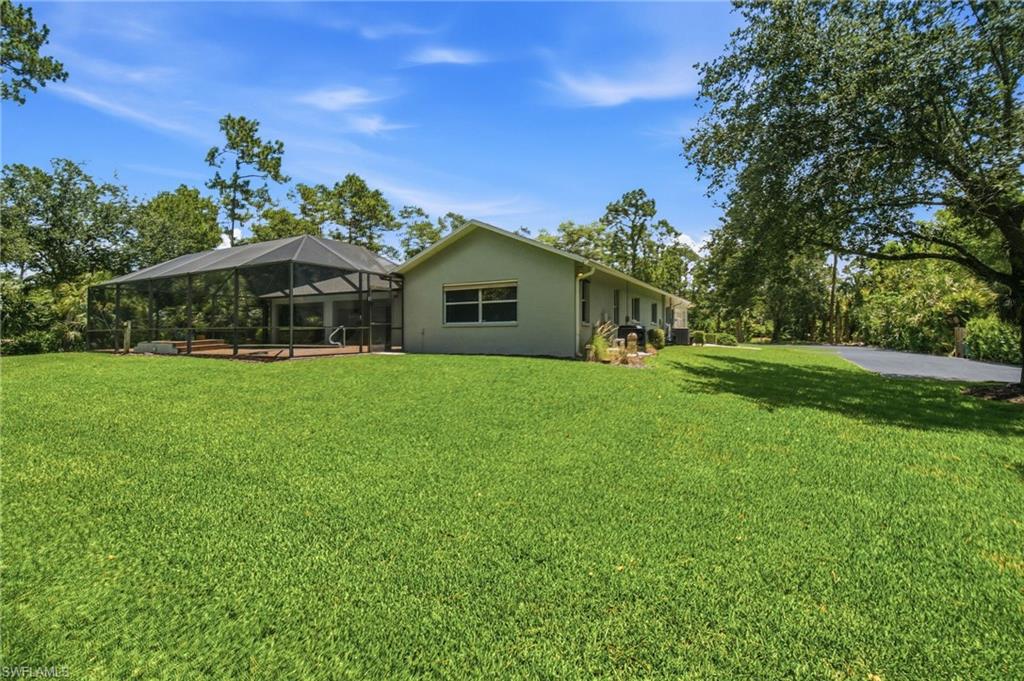 2053 17th Street Southwest Naples, FL 34117 - Photo 24 of 47 a front view of house with a garden