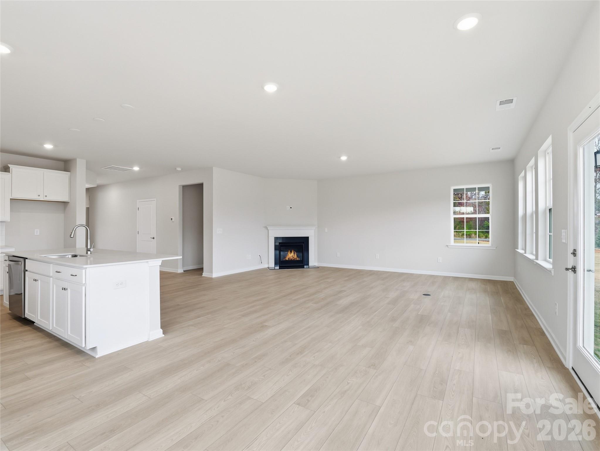 5420 Redbud Road Lancaster, SC 29720 - Photo 16 of 32 an empty room with kitchen appliances and wooden floor