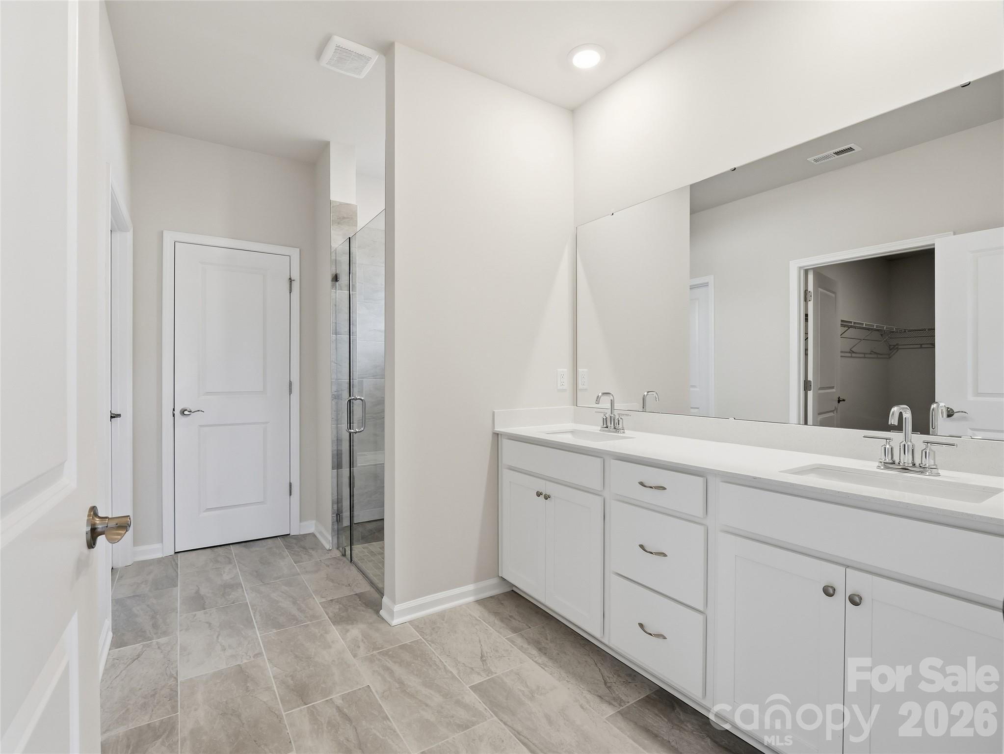 5420 Redbud Road Lancaster, SC 29720 - Photo 21 of 32 a spacious bathroom with a double vanity sink double and mirror
