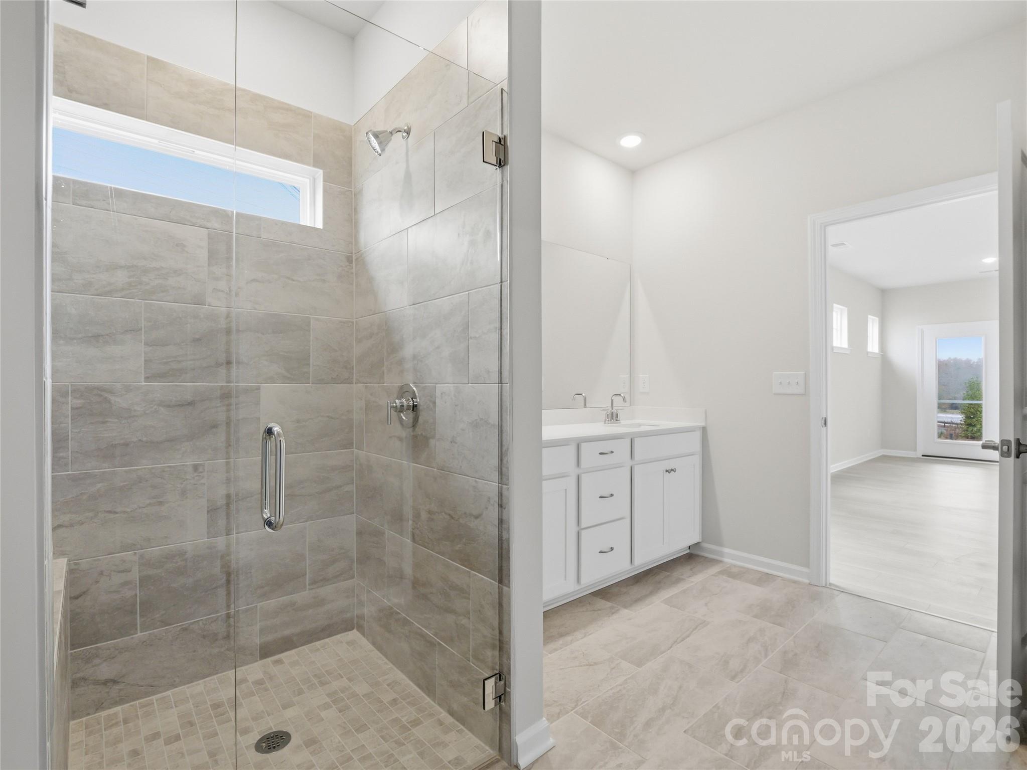 5420 Redbud Road Lancaster, SC 29720 - Photo 22 of 32 a bathroom with a shower sink and mirror
