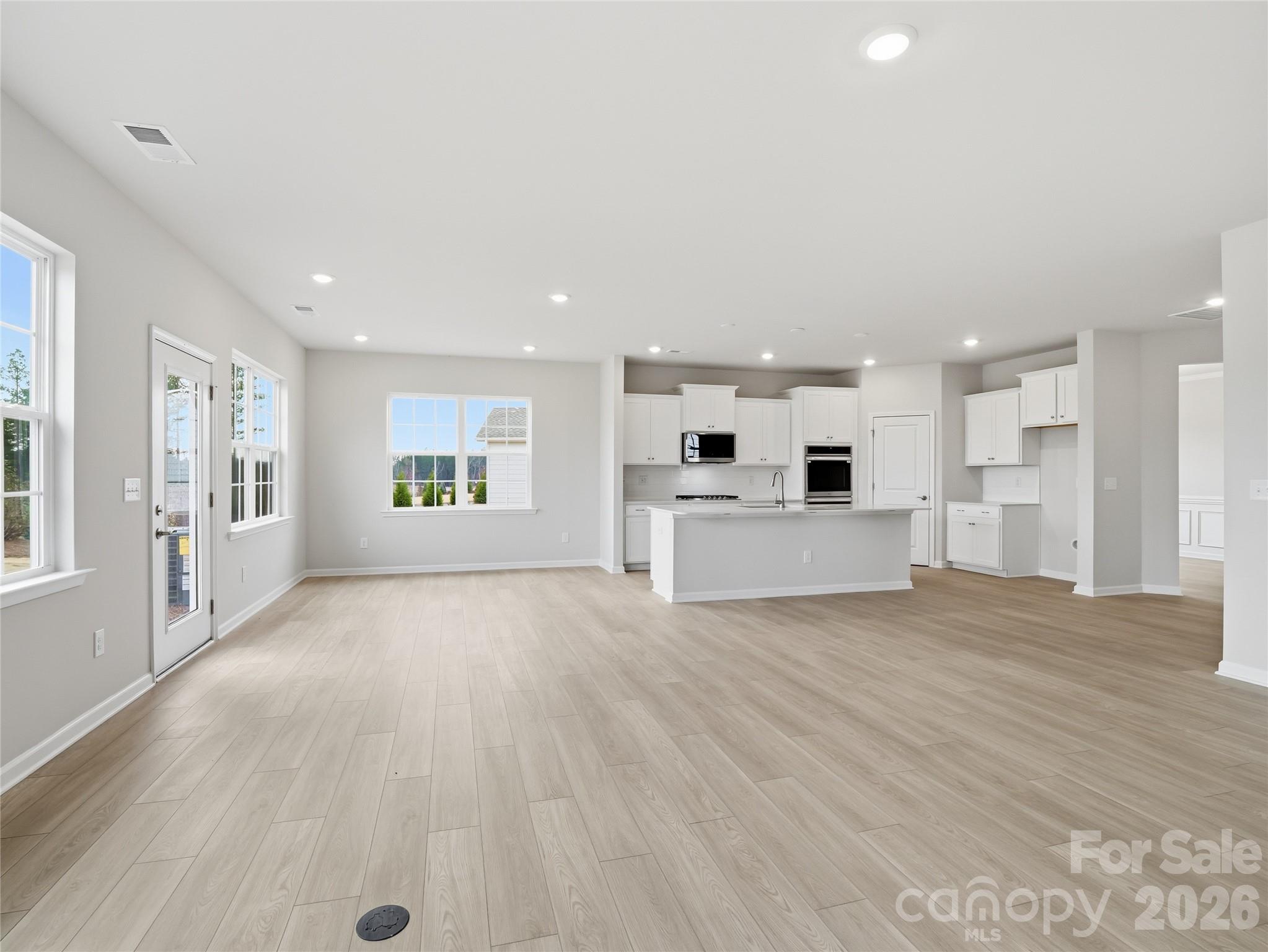 5420 Redbud Road Lancaster, SC 29720 - Photo 7 of 32 a view of a kitchen with a sink and dishwasher kitchen view with wooden floor