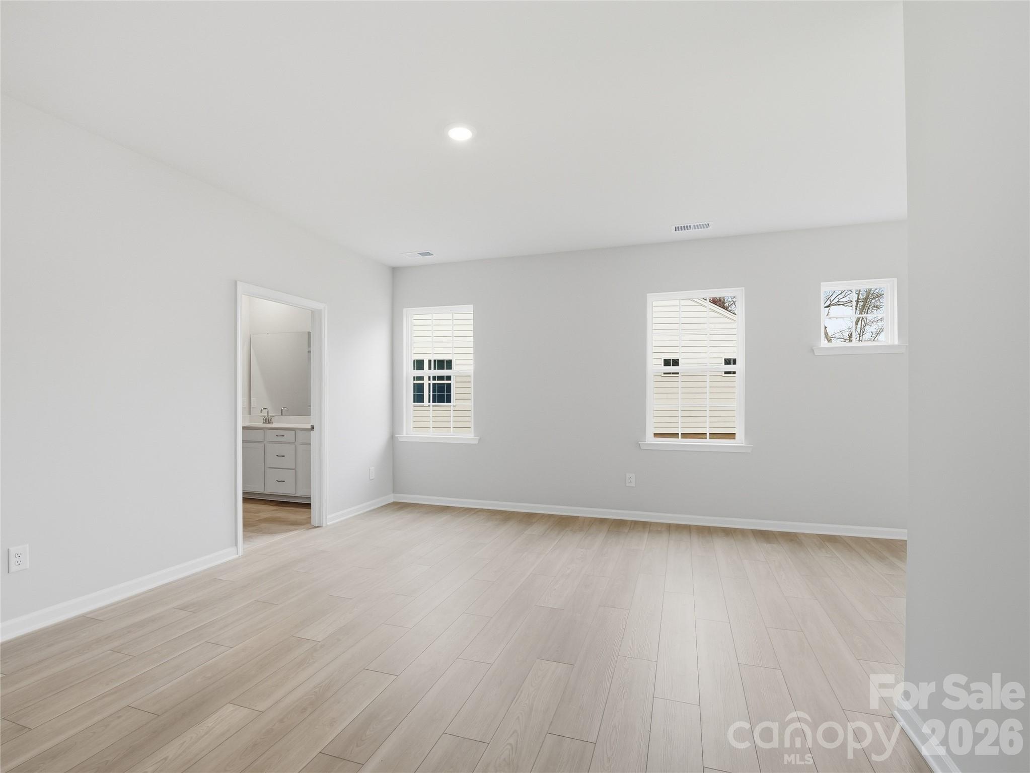 5420 Redbud Road Lancaster, SC 29720 - Photo 8 of 32 an empty room with wooden floor and windows
