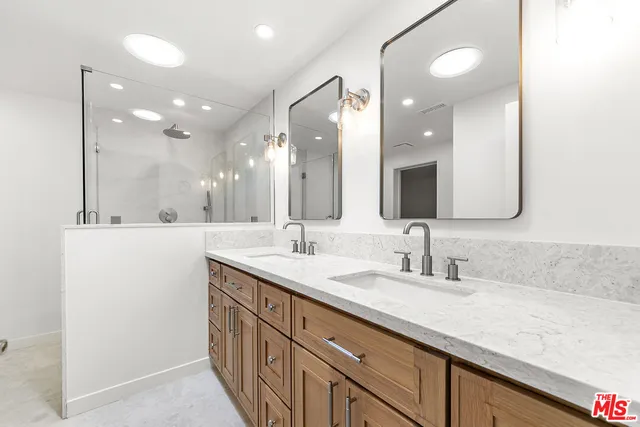 a bathroom with a double vanity sink and a mirror