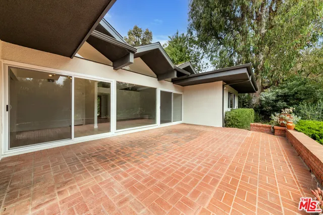 a porch with seating space and yard in the back
