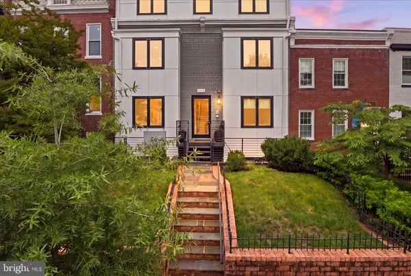 a front view of a brick house with a yard