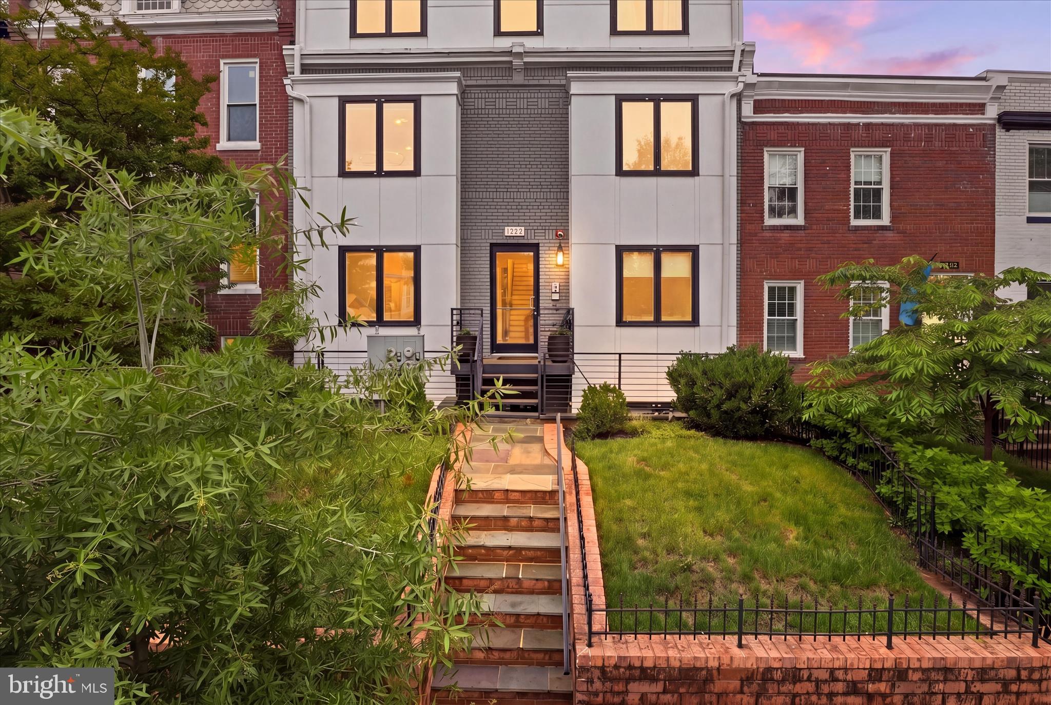 1222 Neal Street Northeast, Unit 3 Washington, DC 20002 - Photo 1 of 38 a front view of a brick house with a yard