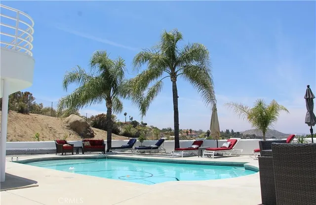 a view of a water with boats and palm trees