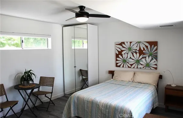 a bedroom with a bed and a chair
