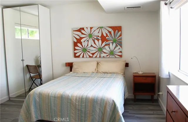 a bedroom with a bed and a dresser