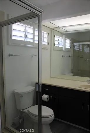 a bathroom with a toilet a sink and window