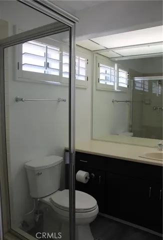 a bathroom with a toilet a sink and window