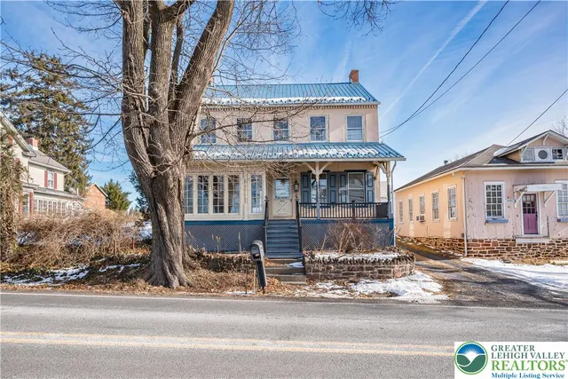a view of a porch with wooden floor and iron stairs
