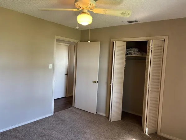 a view of a hallway with wooden shelves