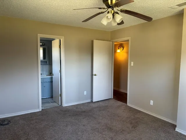 an empty room and chandelier fan