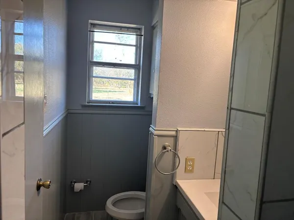 a bathroom with a toilet sink and shower