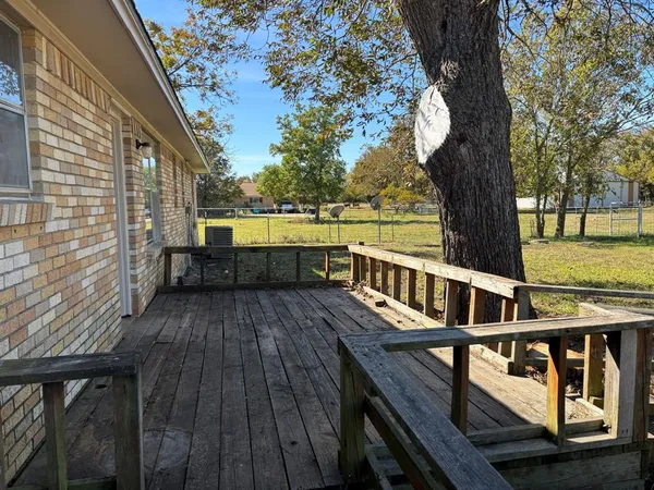 a view of balcony with wooden floor and fence