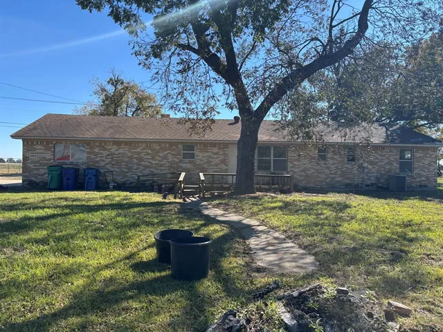 a view of a backyard with plants and a patio