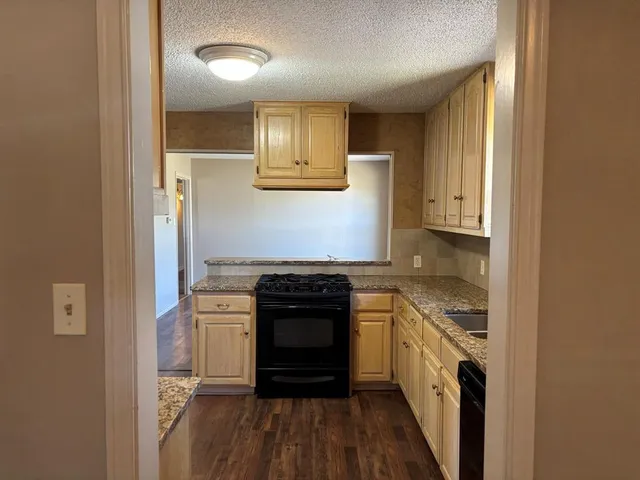 a kitchen with a stove and a refrigerator