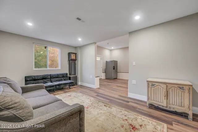 a living room with furniture and a rug