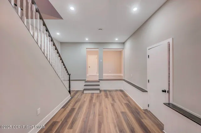 a view of entryway and hall with wooden floor