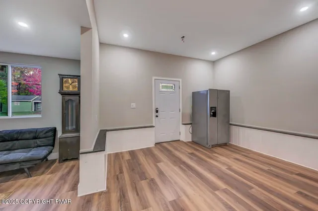 a view of a kitchen with a refrigerator and a chair