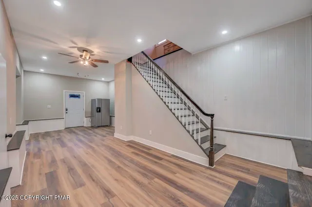 a kitchen with stainless steel appliances kitchen island granite countertop a sink and cabinets