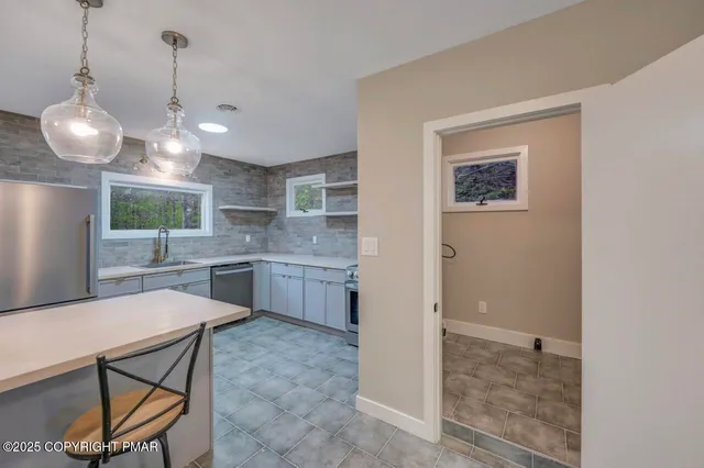 a kitchen with a sink and a refrigerator