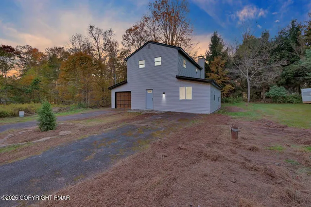 a front view of house with yard and trees