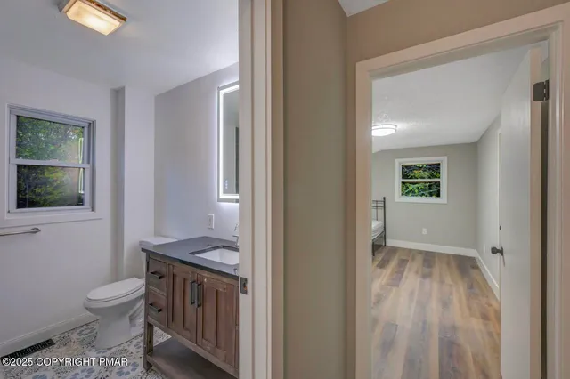 a bedroom with a bed and a wooden floor