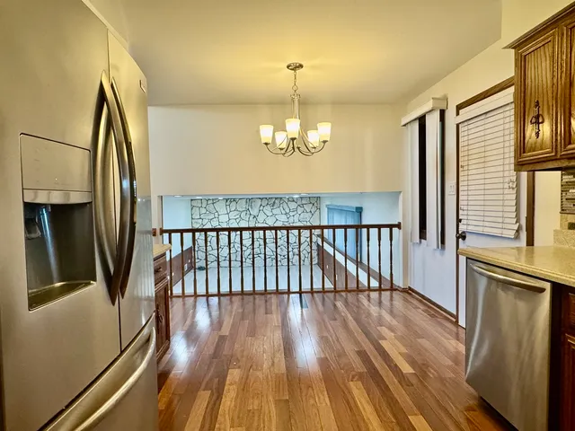 a view of a room with wooden floor and staircase