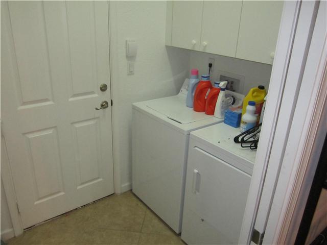 255 Southwest Walking Path Stuart, FL 34997 - Photo 14 of 16 a utility room with dryer and washer