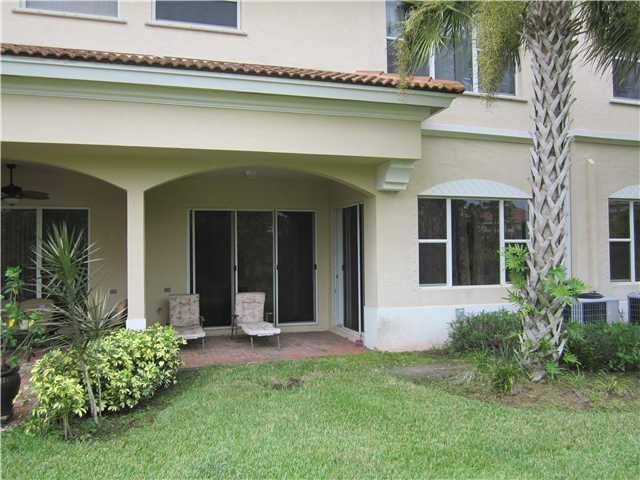 255 Southwest Walking Path Stuart, FL 34997 - Photo 3 of 16 a front view of a house with a garden and plants